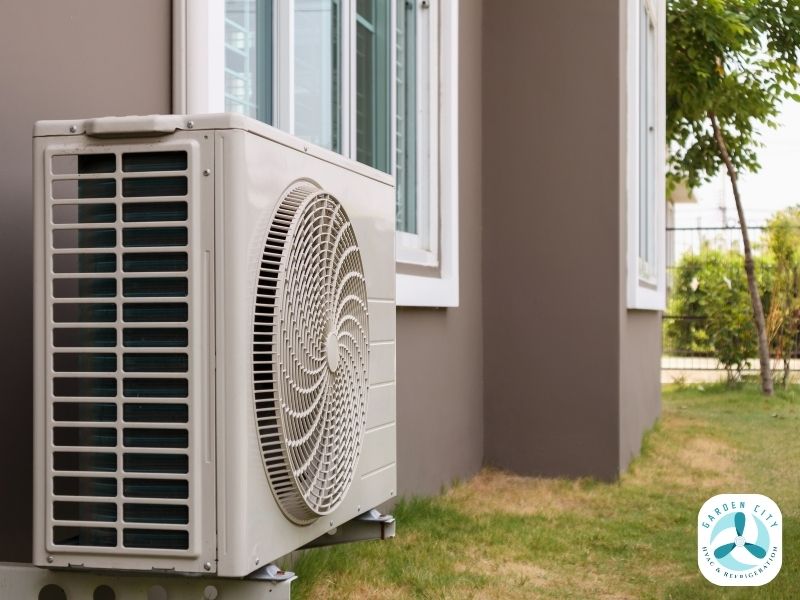 A close-up of an air conditioner's outdoor unit on the side of a house, used to illustrate a guide on aircon sizing in Toowoomba.
