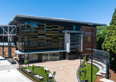 Exterior of a modern Design Engineering & Technology Centre with brick walls, glass facade, and layered horizontal fins/finsense on the front.