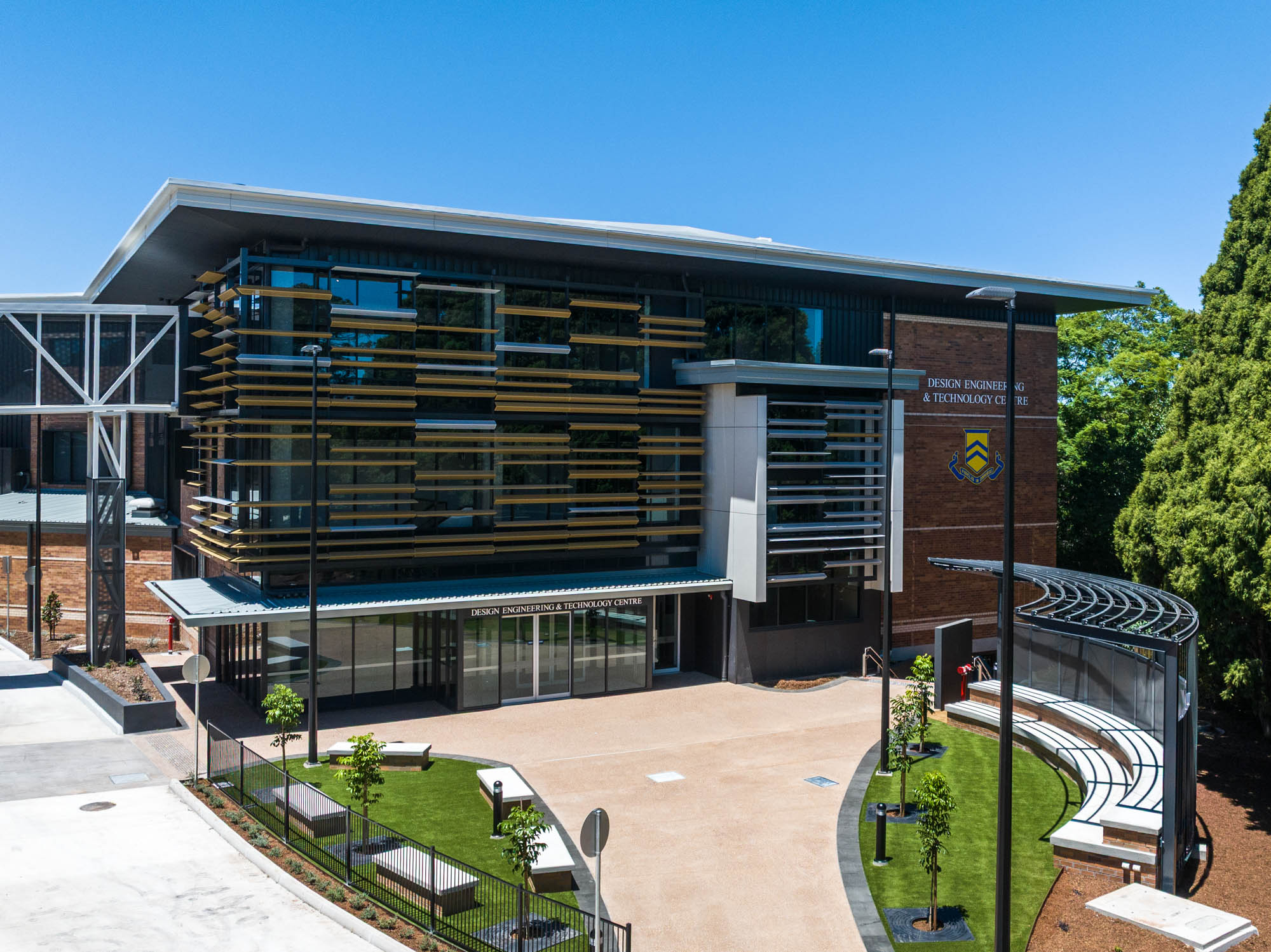 default Exterior of a modern Design Engineering & Technology Centre with brick walls, glass facade, and layered horizontal fins/finsense on the front.